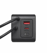 A close-up of a black rectangular power brick showing two red USB-A output ports and one red USB-C input port with labels OUT, IN/OUT, and a power button icon.
